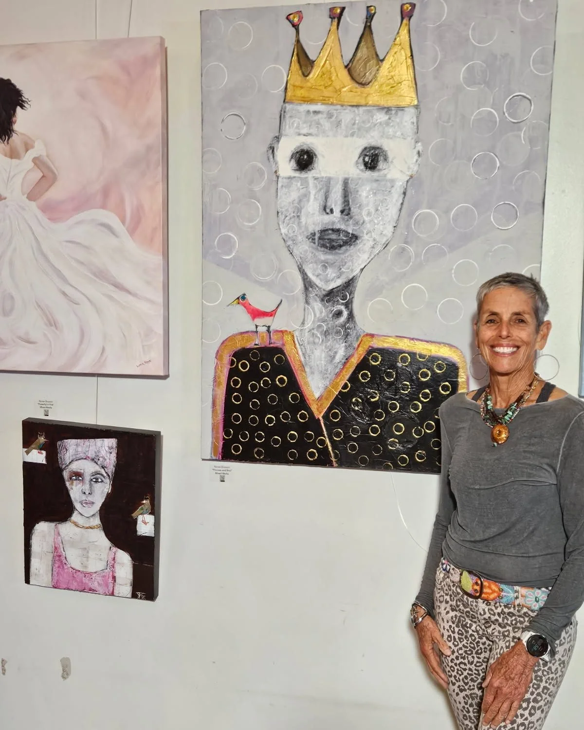 Renee stands next to two of three works, &ldquo;Powerful in Pink&rdquo; and &quot;Princess &amp; Bird,&quot; included in &quot;She Persists: Journeys of Self-Discovery and Unwavering Spirit,&quot; a Foster Gallery Outreach Special Exhibit presented b