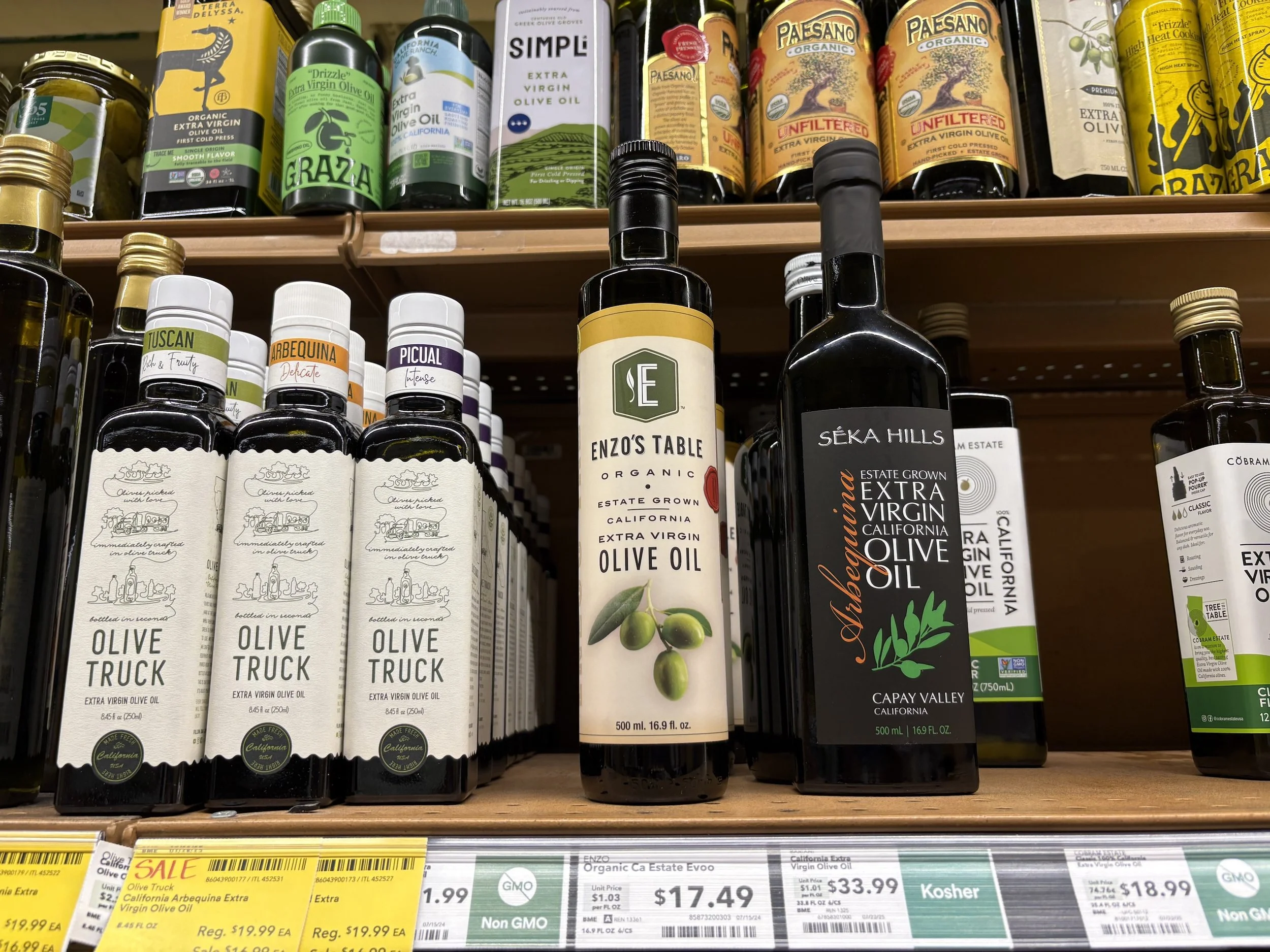 Olive oil bottles on supermarket shelf