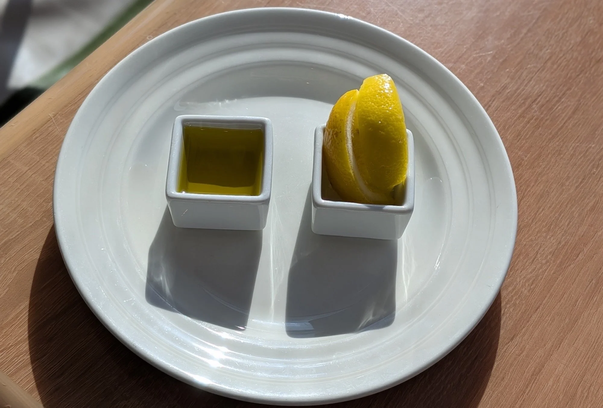An olive oil shot with a side of lemon