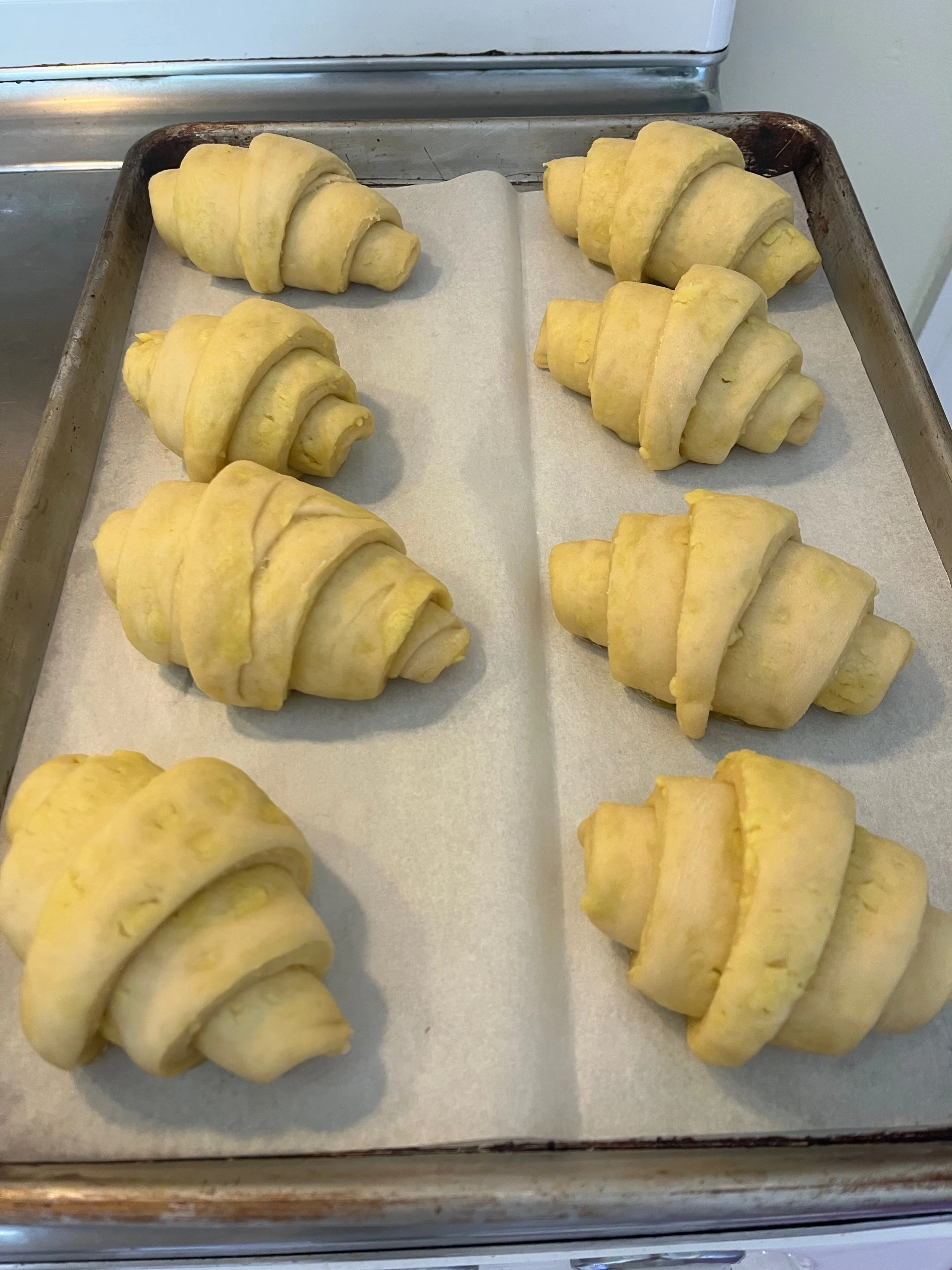 The rolled croissant dough after proofing