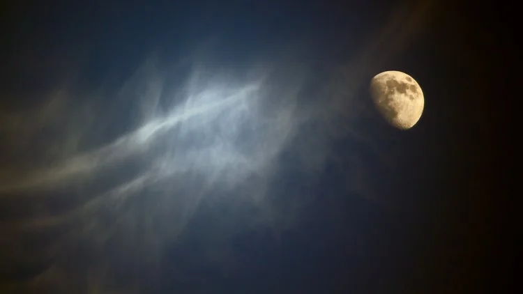 Night sky with the moon and wispy clouds.