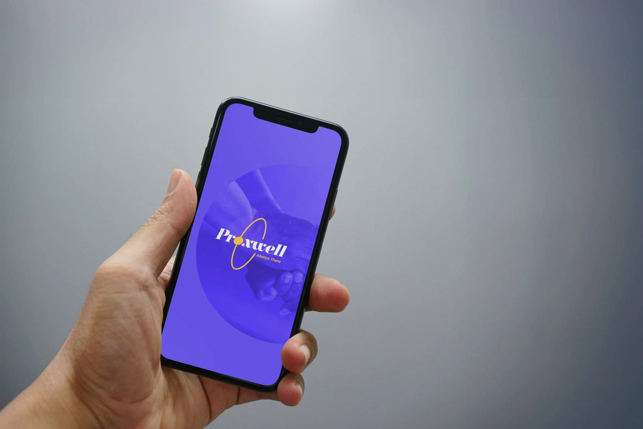 A person holding an iPhone displaying a purple and blue app called "ProWell" with the tagline "Always There," against a plain gray background.