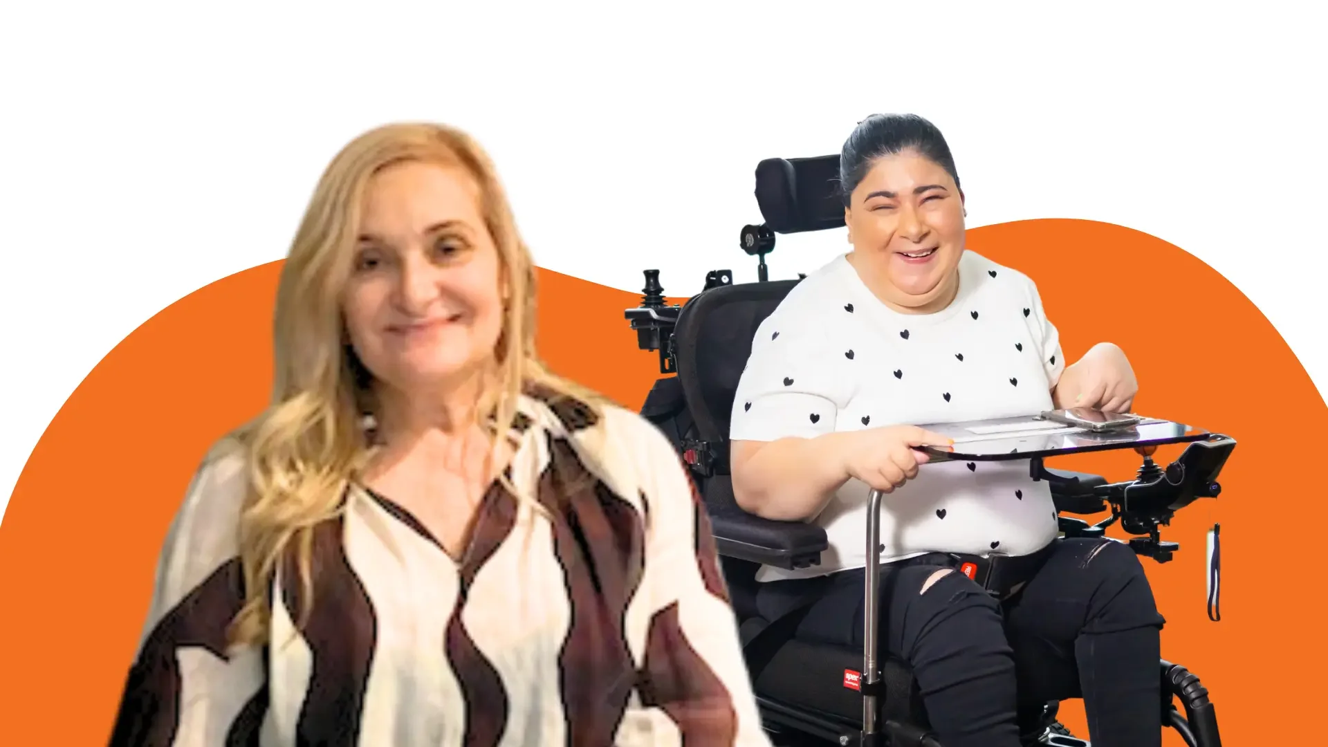 Two women smiling, one using a powered wheelchair, against an orange background