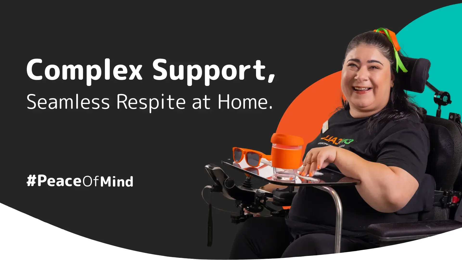 Wheelchair user smiling while receiving complex in-home support.