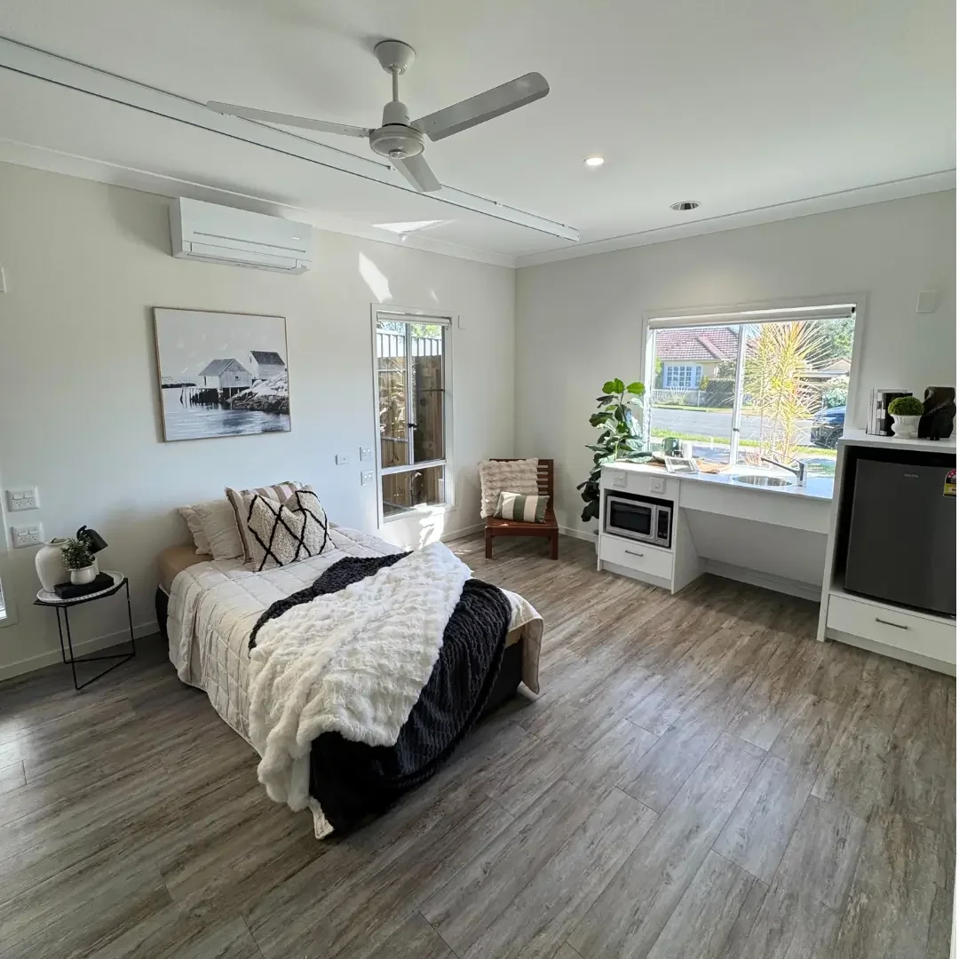 Bedroom and kitchenette in a QLD supported accommodation home designed for comfort and independence.