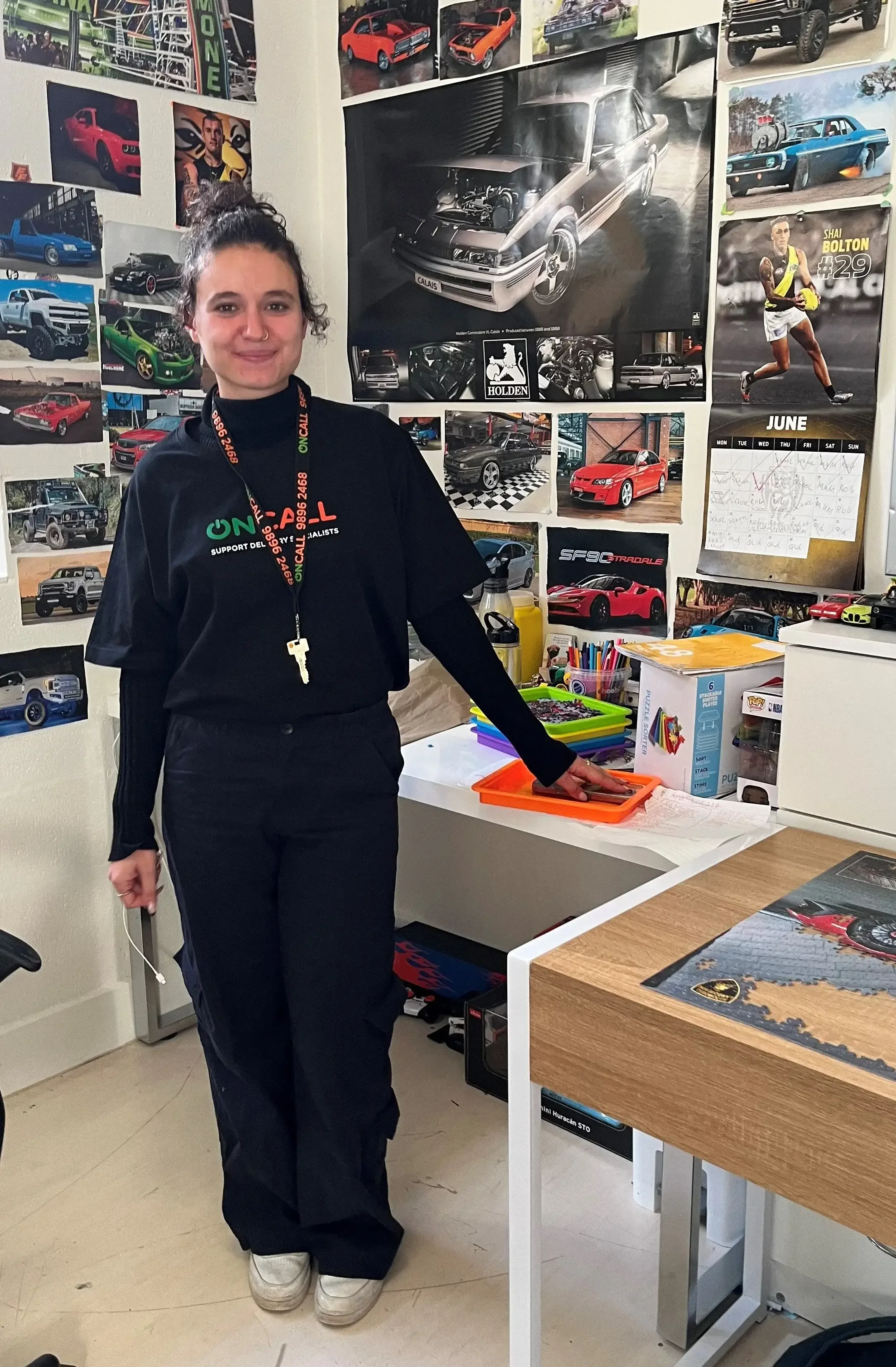 Support worker smiling in an indoor workspace environment