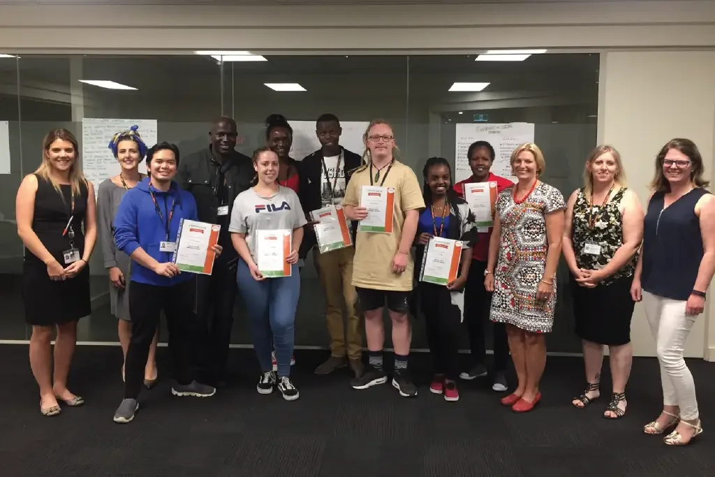 ONCALL staff and program participants holding certificates after training session