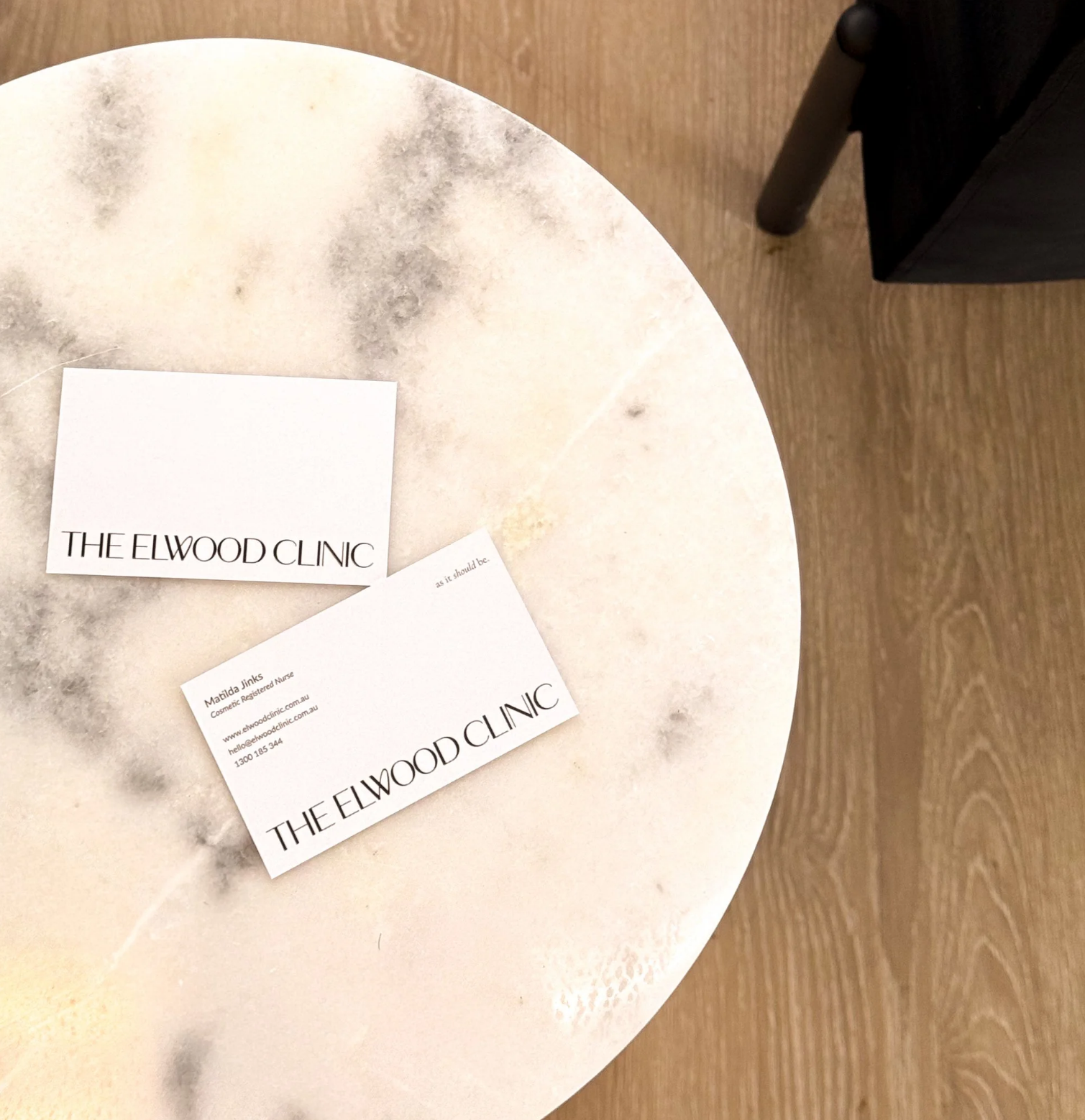 The Elwood Clinic business card design on marble — print collateral by Sunday Noon