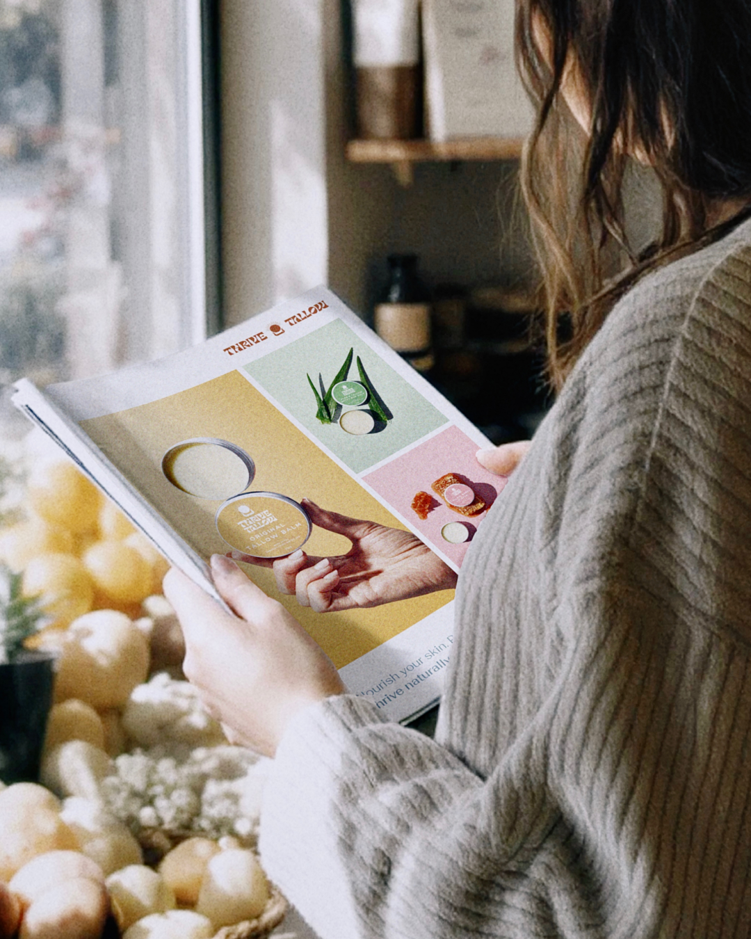 A woman holding a brochure or flyer in a grocery store, with onions in the background.