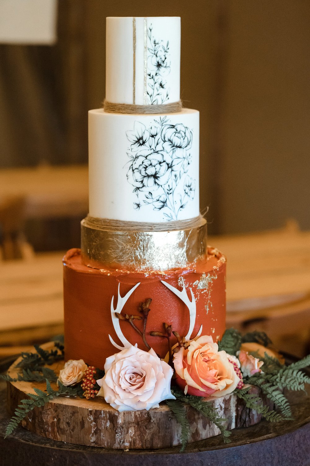 wild wedding cake with stag detailing and gold leaf