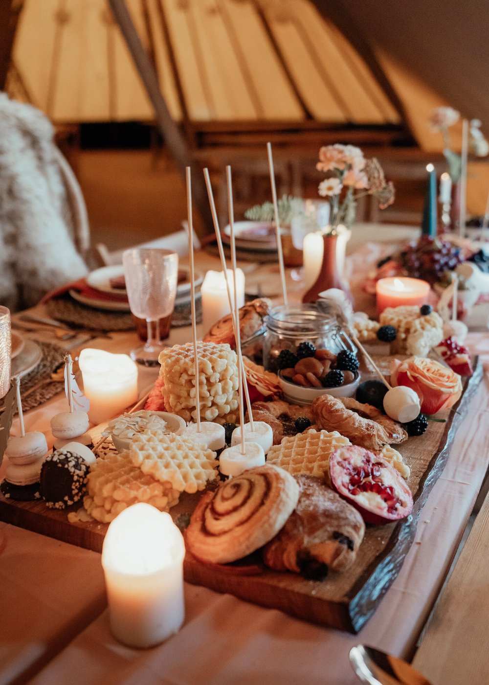 autumnal tipi styling with fur throws candles and grazing table