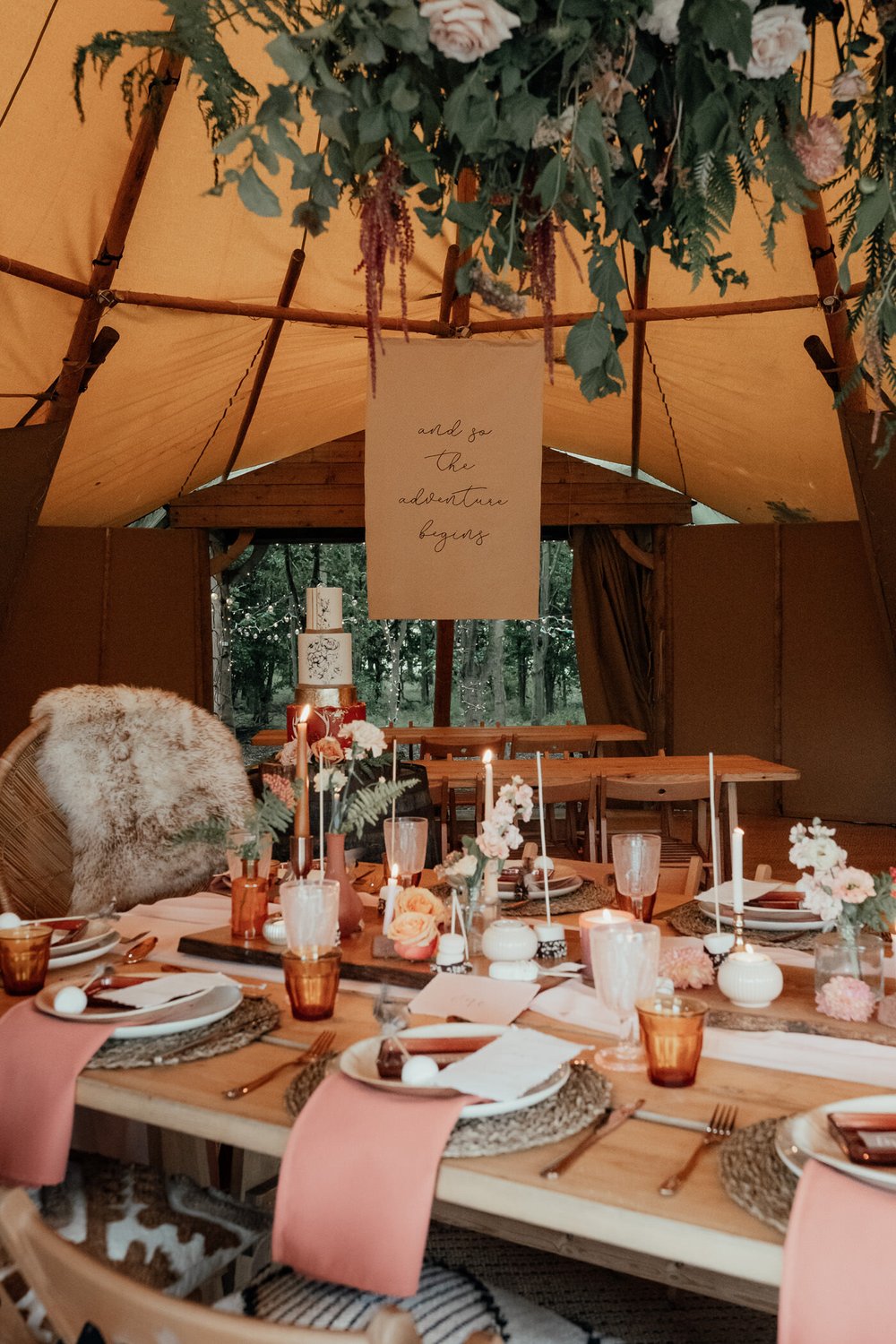 hanging floral centrepiece over rustic styled boho wedding tablescape in top hat tipi
