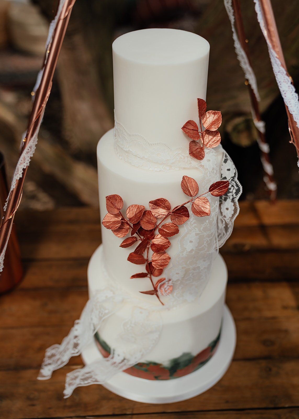simple boho wedding cake with copper leaf decoration