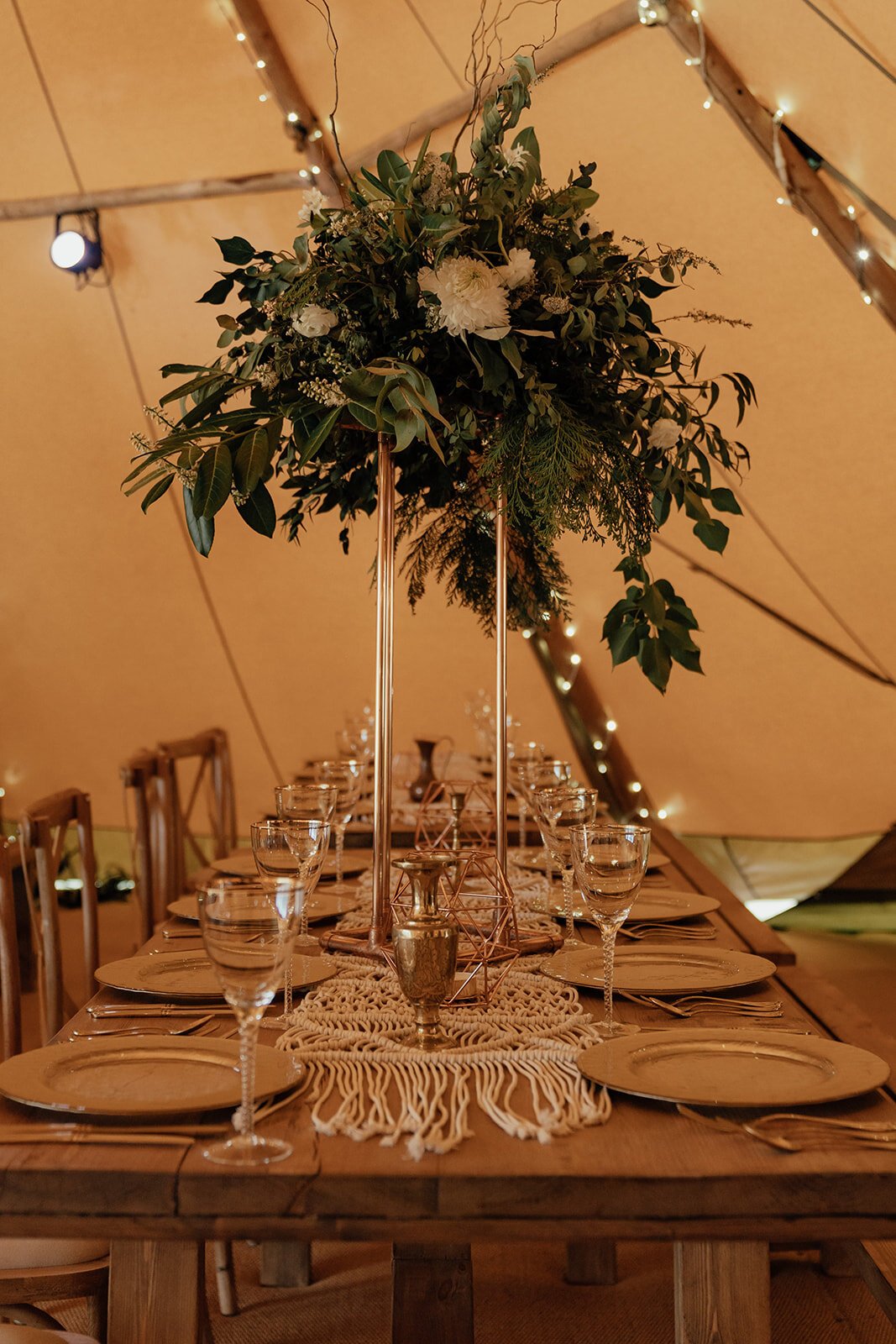tall foliage wedding table centrepiece in tipi