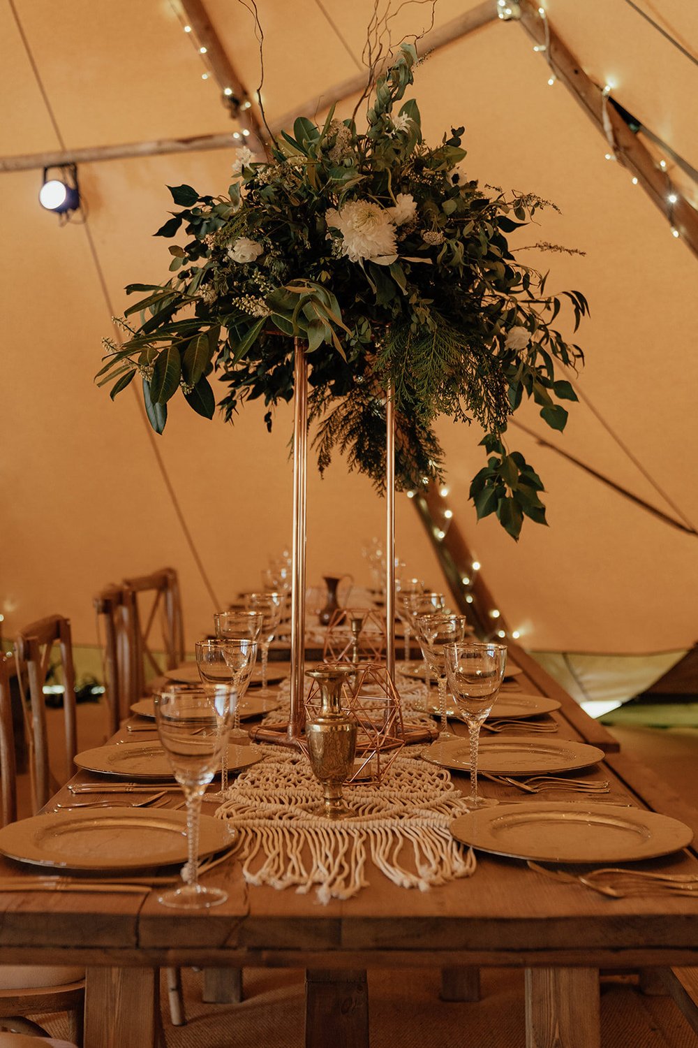 tall foliage wedding table centrepiece in tipi