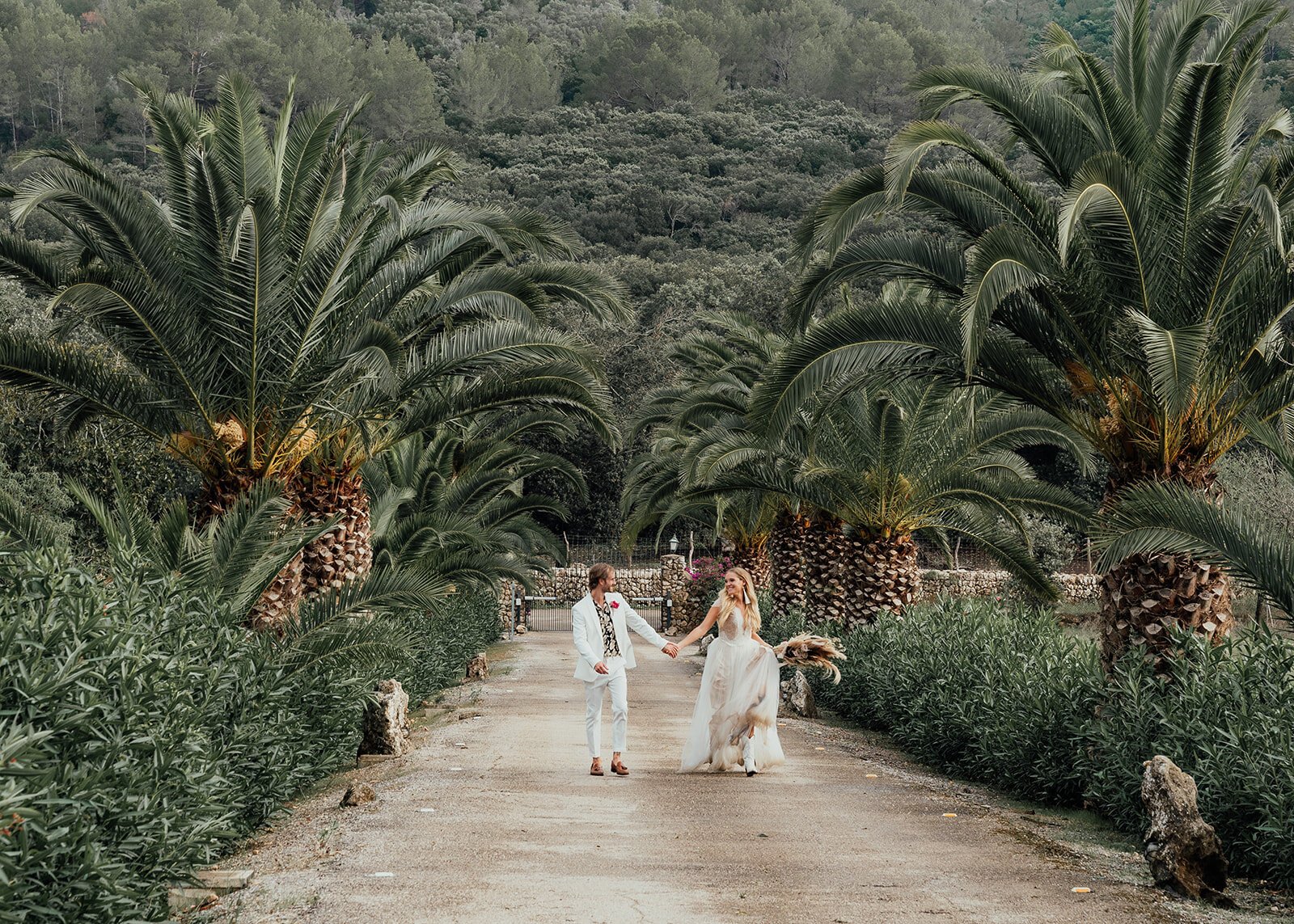 palm tree wedding with couple running