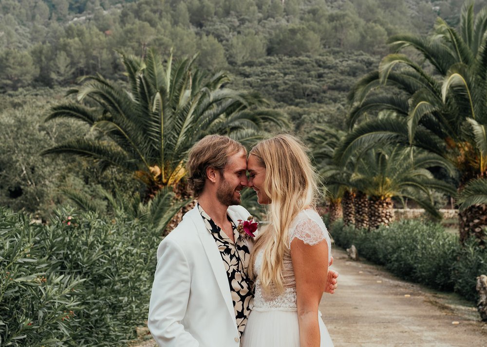 nose to nose wedding photography posing with palm trees