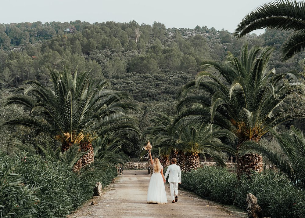 boho style wedding exit with palm trees
