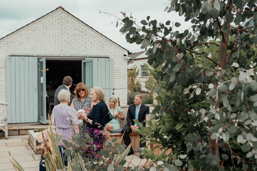 a few wedding guests shot through the trees at a wedding