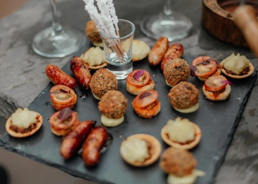 savoury canapes on a black slate at a wedding 