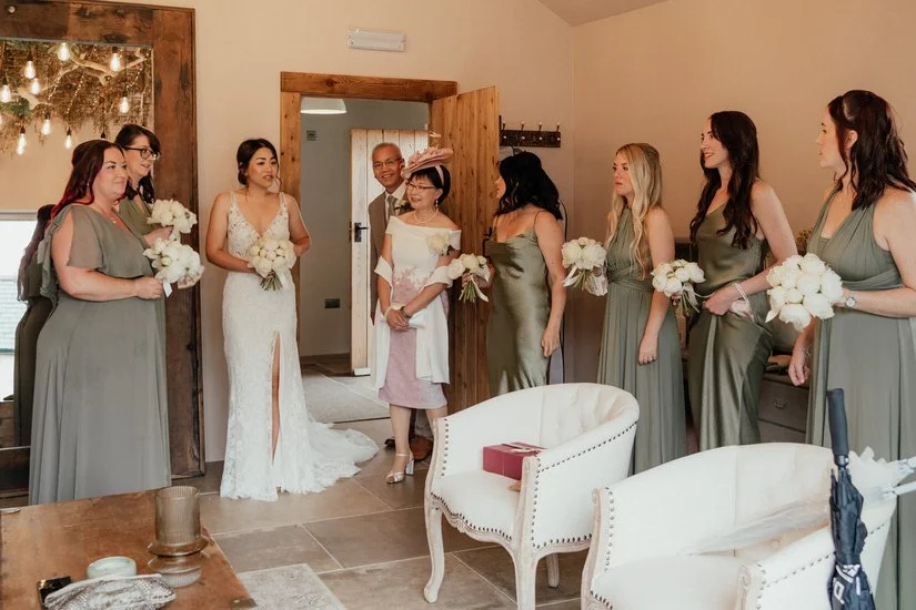 bride, her parents &amp; her bridesmaids at the pre-ceremony room at Eden Barn wedding venue
