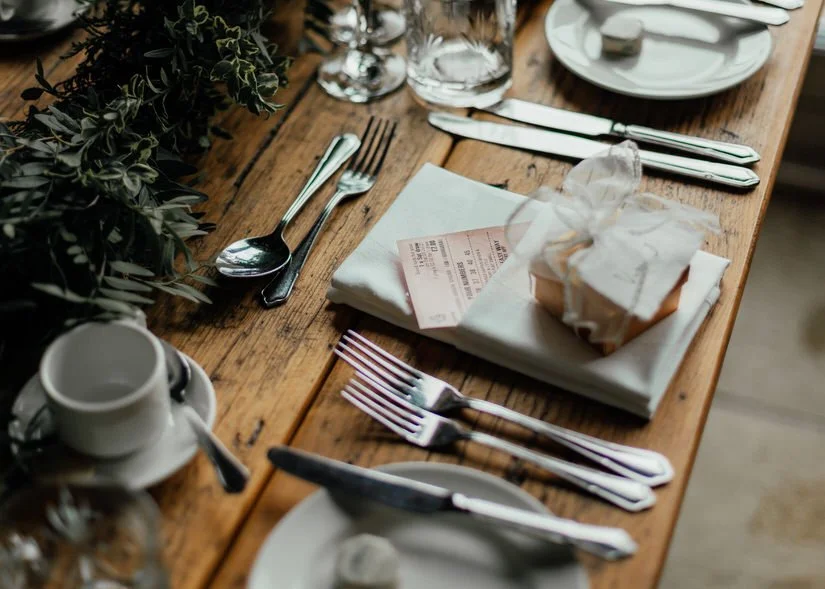 lottery ticket wedding favour poking out of a napkin at a wedding breakfast table