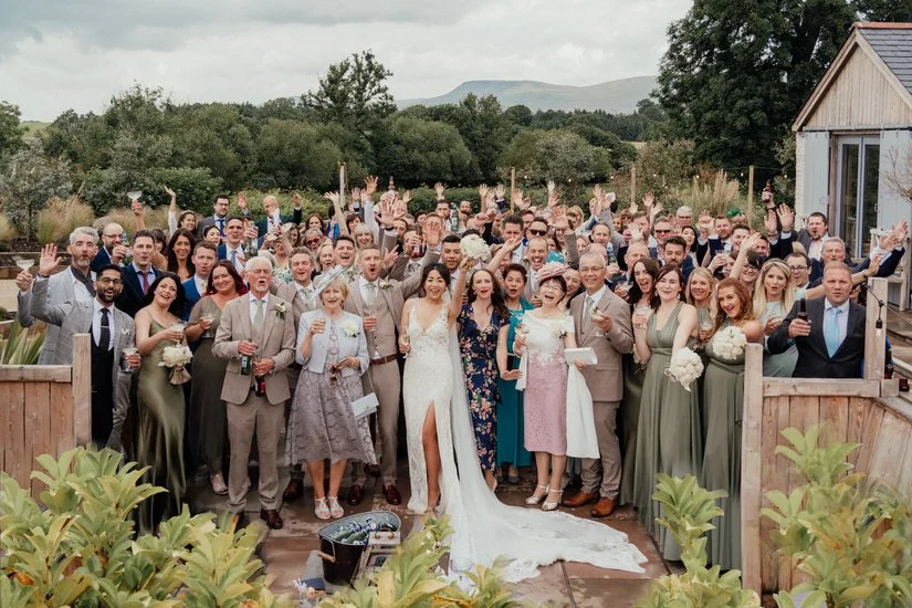 all wedding guests in a group photo 