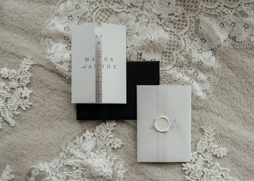 monochrome wedding invitation on a lace background