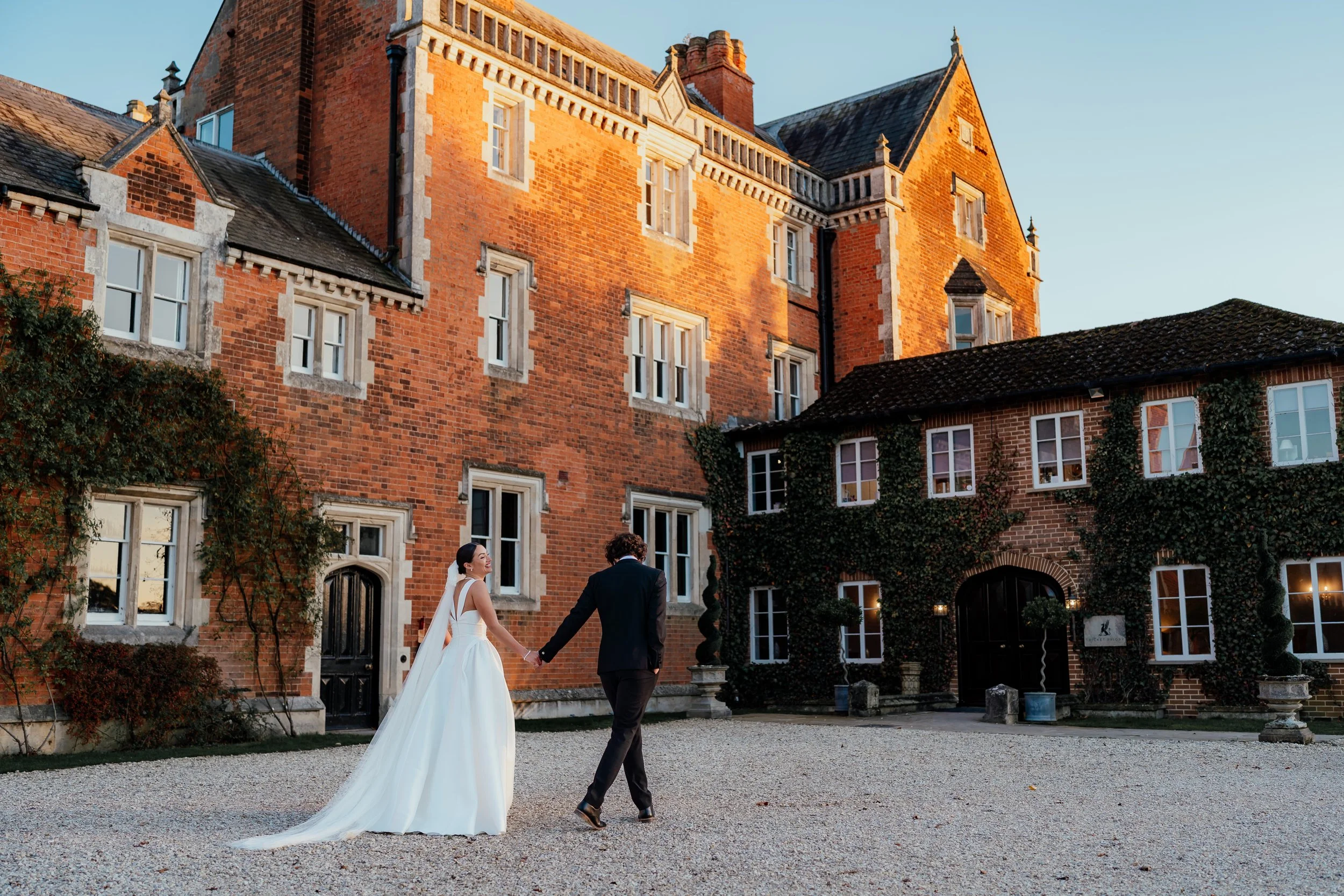 bride & groom outside the entrance to Thicket Priorywedding venue