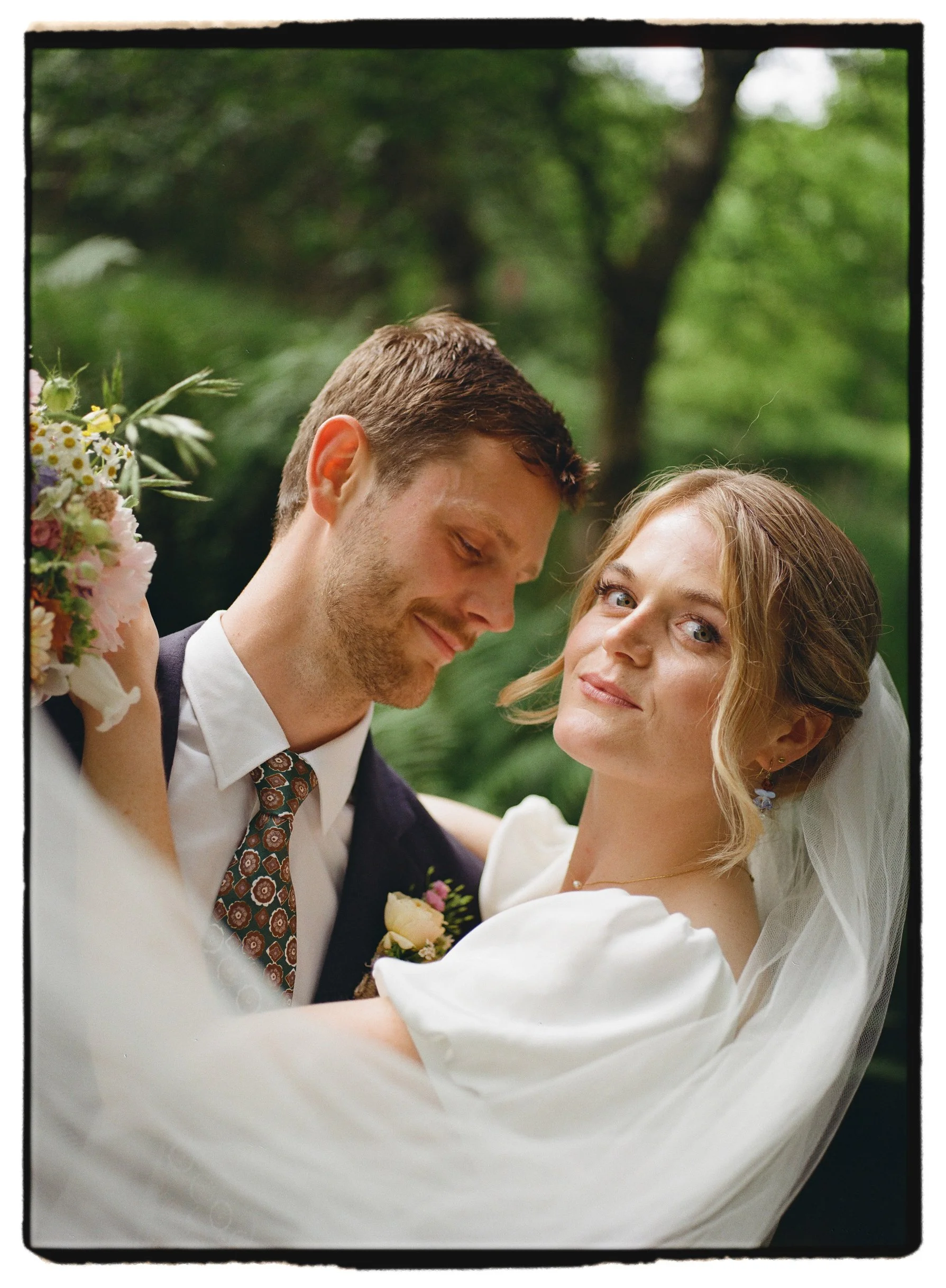 Bride and groom posing in woodland at The Gathering Edale wedding in the peak District shot on 35mm analogue film
