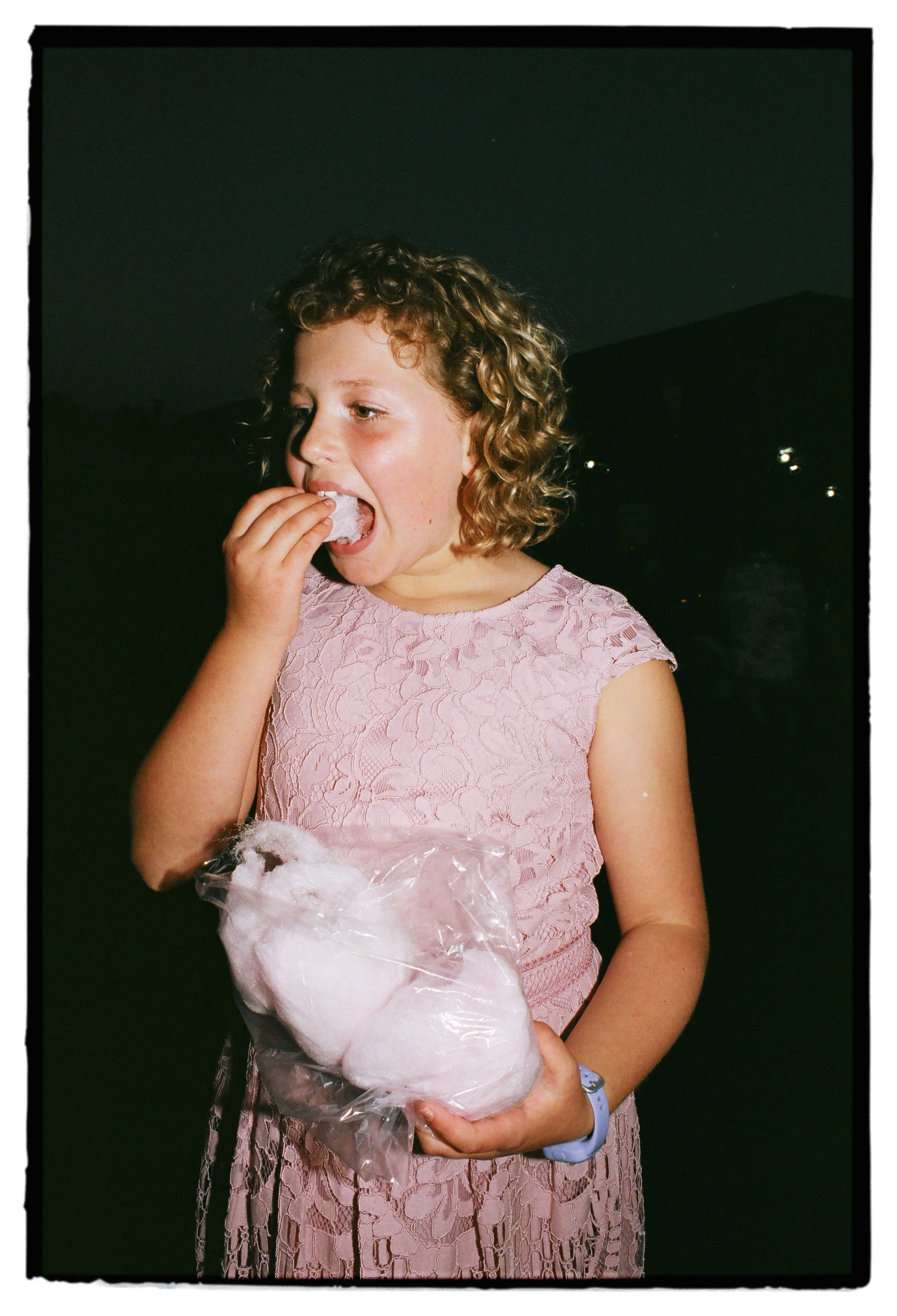 girl eating candyfloss at a wedding on analogue film