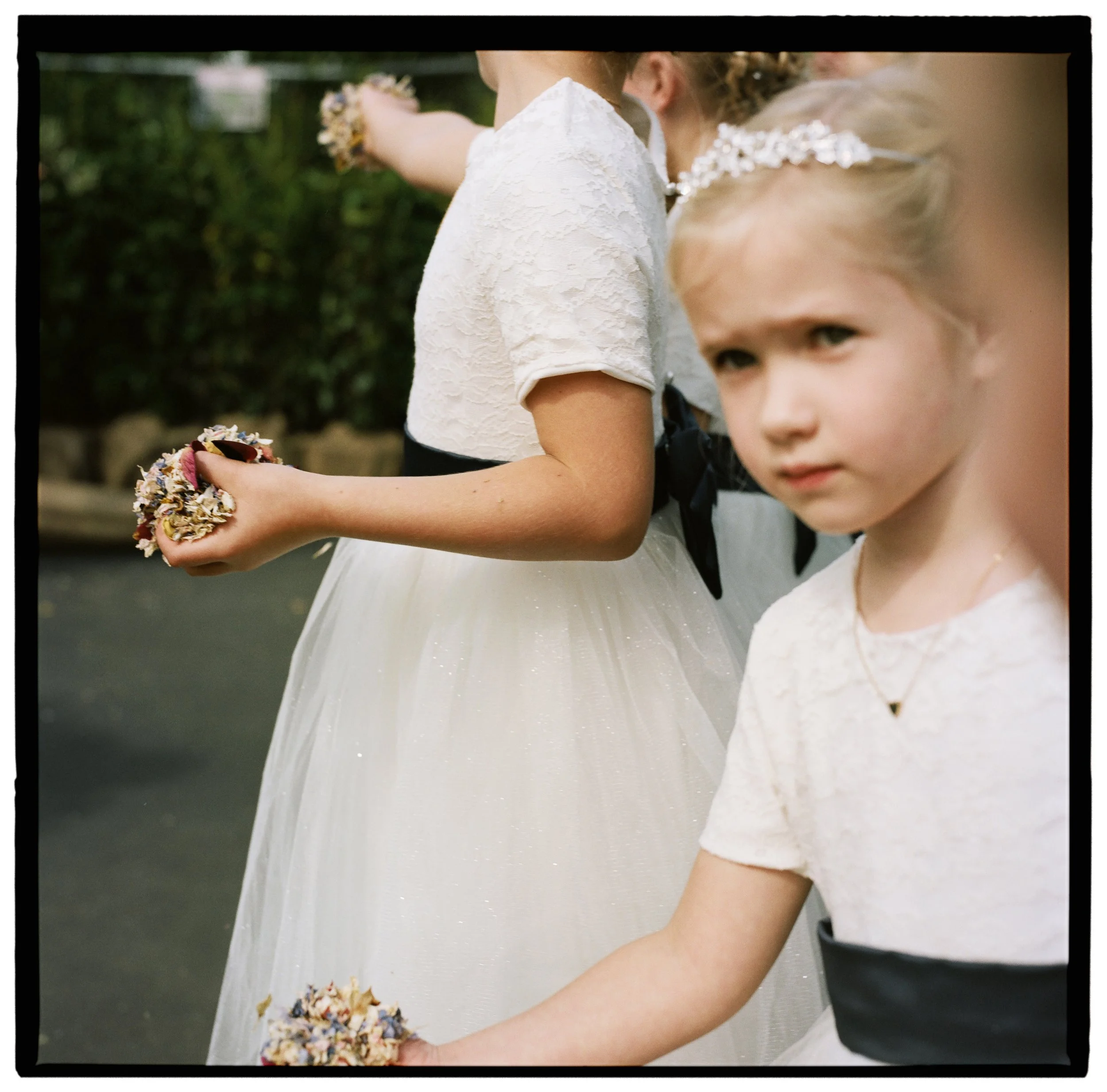 flower girls holding confetti shot on medium format film