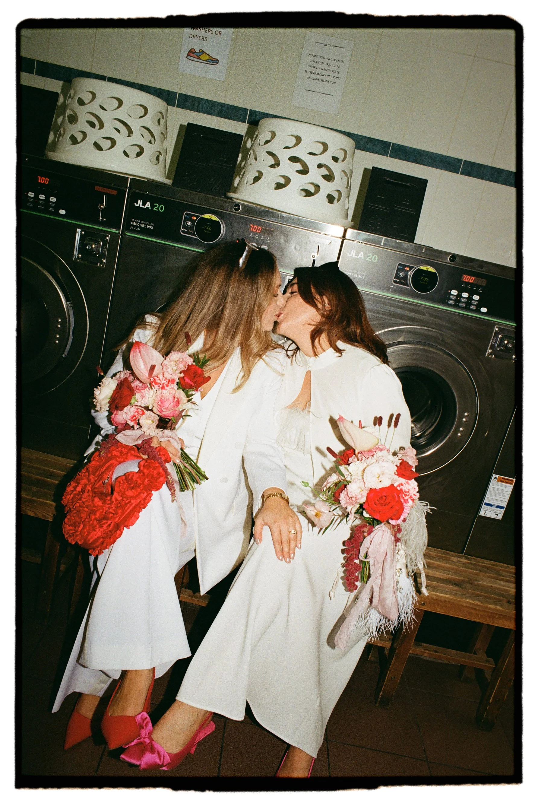 Laundry wedding shoot lesbian wedding Brides in London kissing on 35mm film