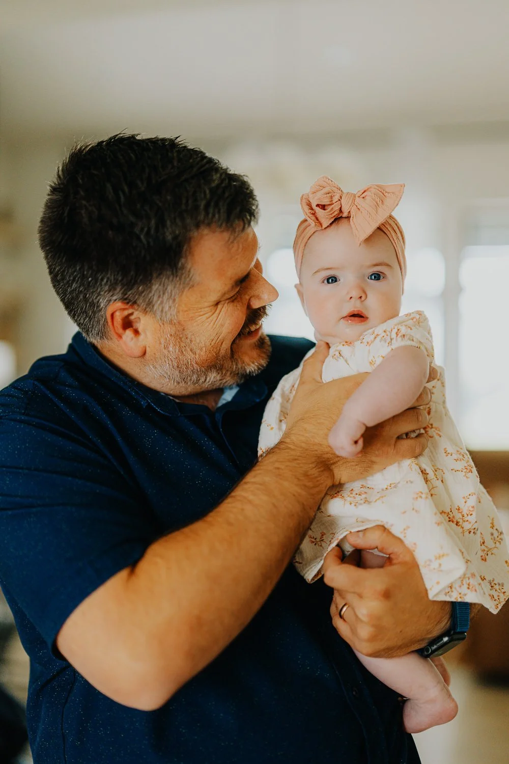 Lincoln family photography of a young dad and his baby happy and smiling