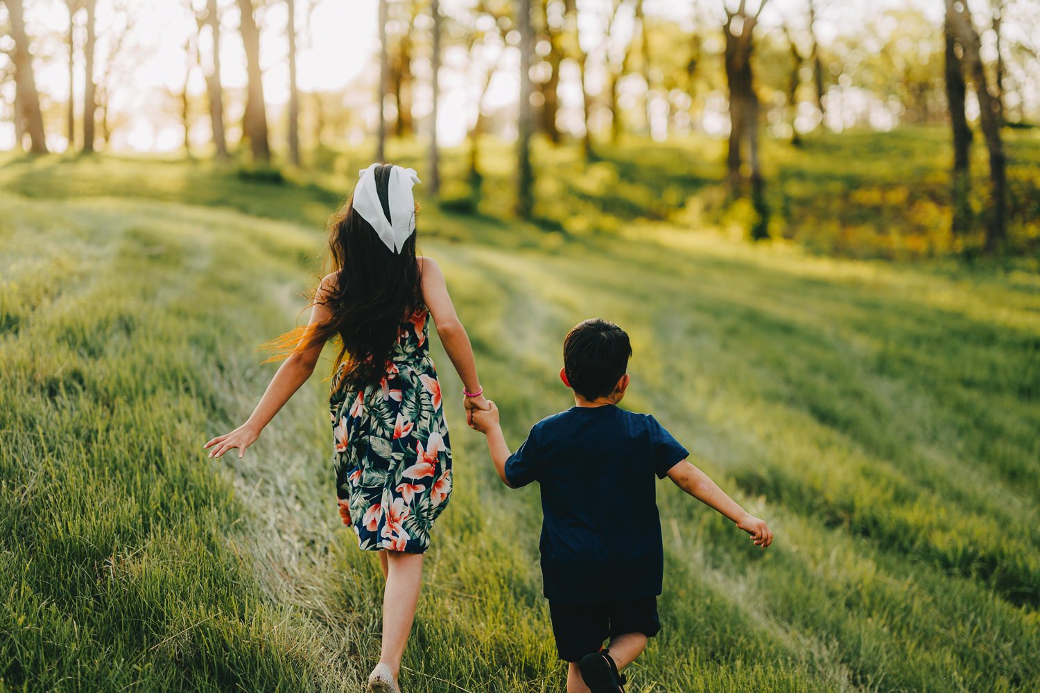kids running through tall grass at Pioneers Park in Lincoln Nebraska