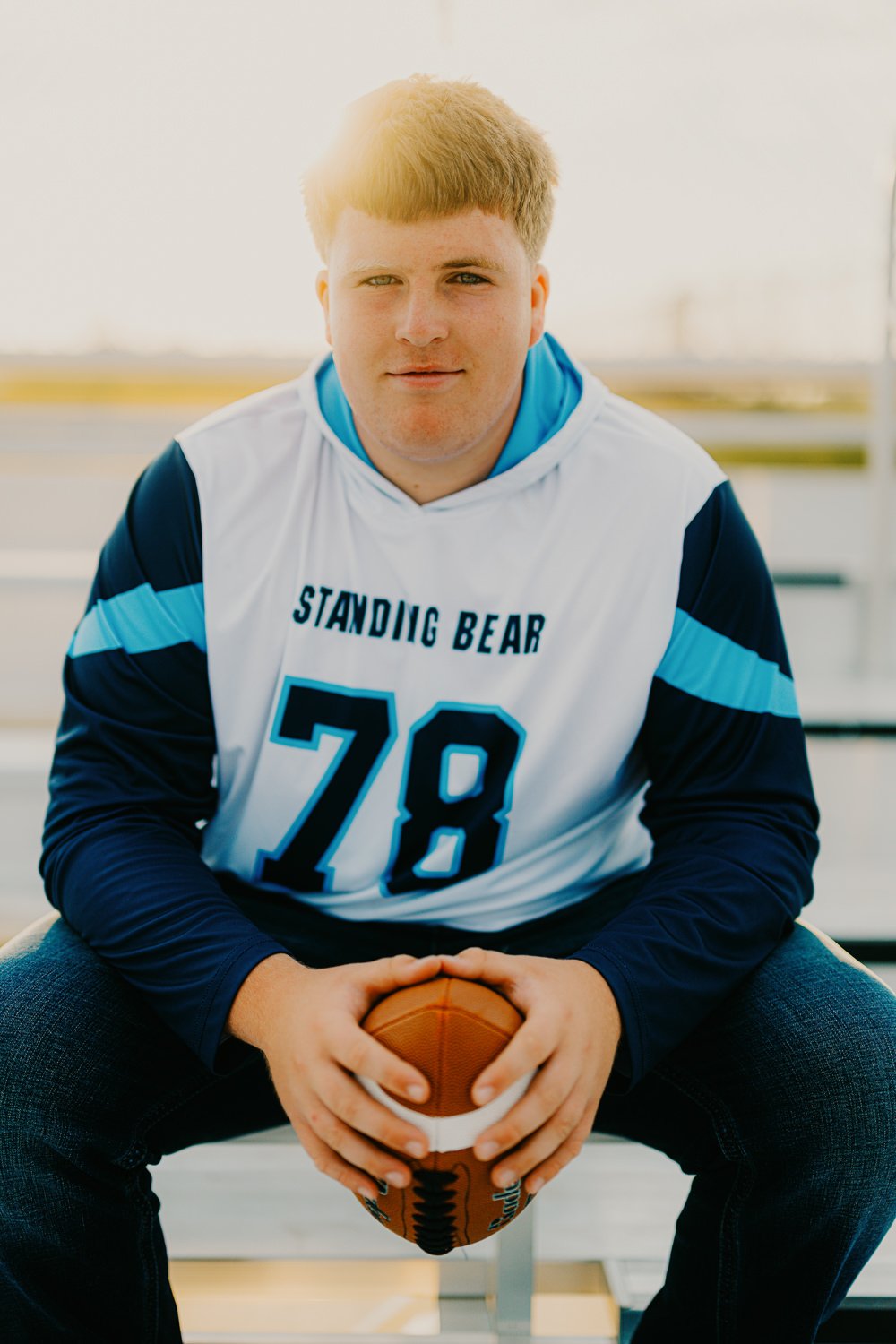 1. Senior photos on a high school football field in Lincoln Nebraska