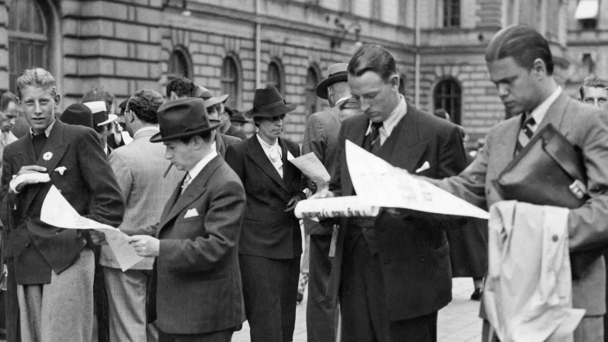 Black and white photograph of people reading newspapers outside Central Station in Stockholm, two days after the outbreak of the Second World War