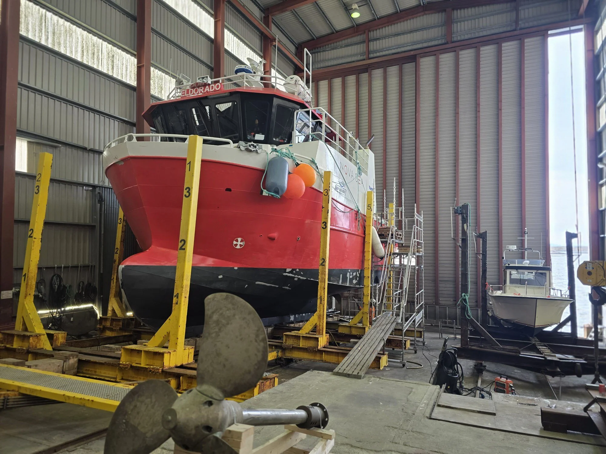 JakMek boat for repair in workshop hall