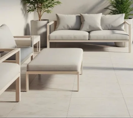 Modern outdoor patio with seating furniture on a smooth concrete surface, representing custom concrete patio installation for outdoor living spaces.