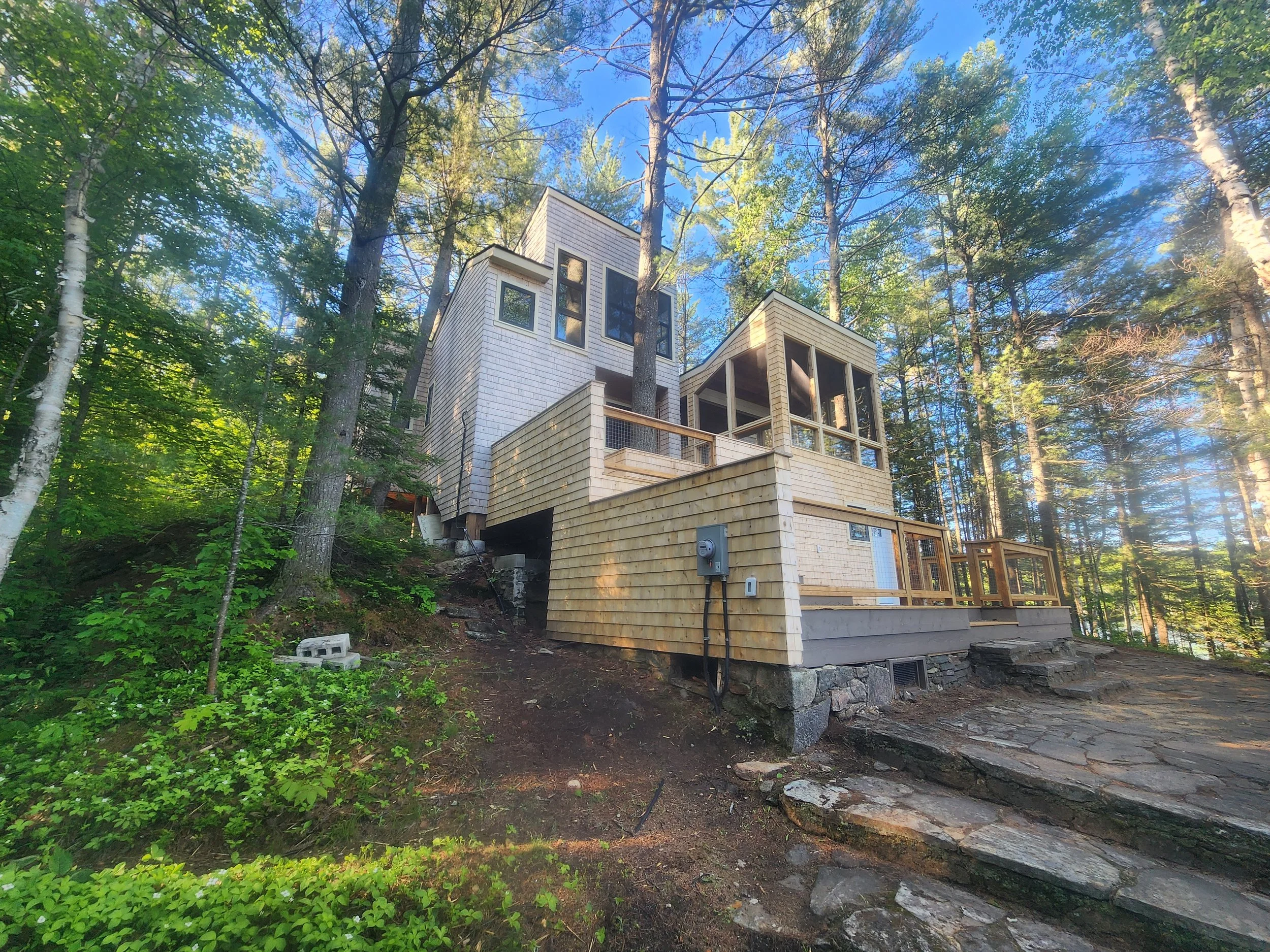 ground-up-constructing-muskoka-cottage-exterior-side-deck.jpg