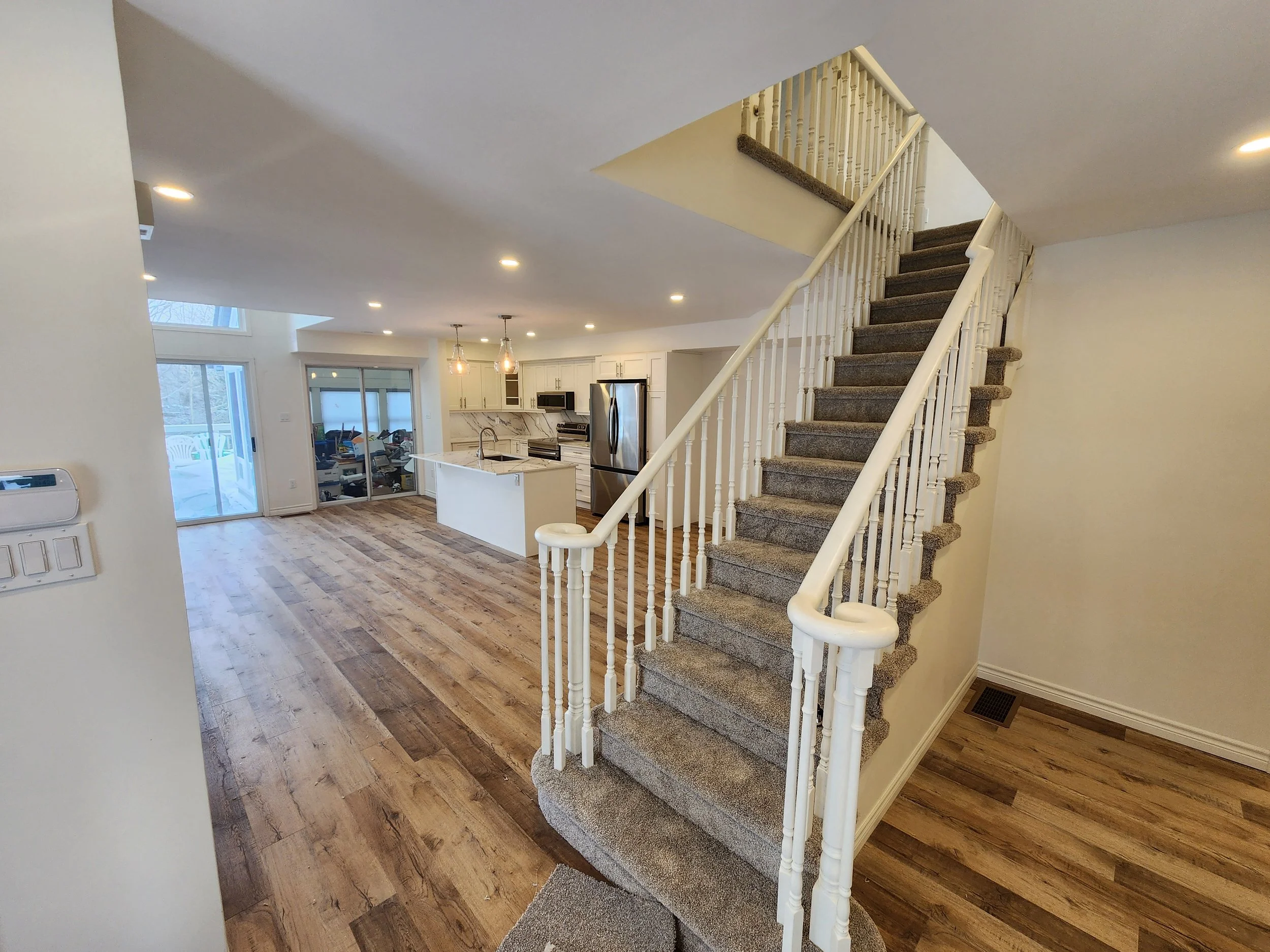 open-concept-home-renovation-staircase-kitchen-living-room-gravenhurst-muskoka.jpg
