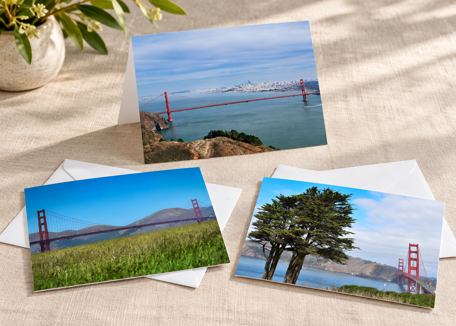 Three landscape bridge cards on linen desk.png