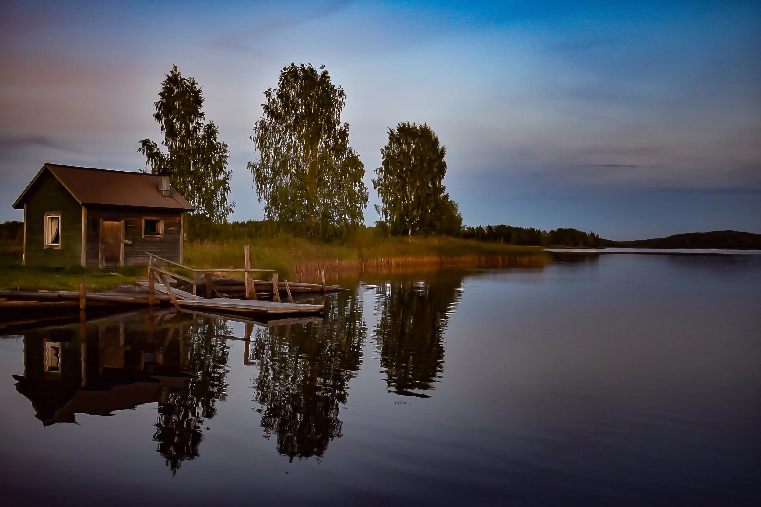 A serene lakeside scene at dusk with a small wooden cabin and a dock, surrounded by tall trees and reflecting calm water under a partly cloudy sky.