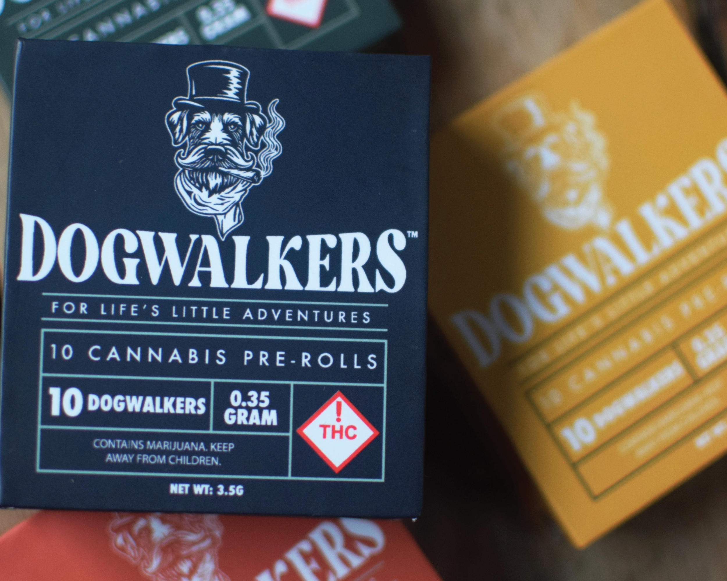 Package of Dogwalkers cannabis pre-rolls featuring a cartoon dog wearing a top hat and smoking a cigar.