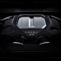 Car engine immobiliser and engine with Audi branding in dim lighting.