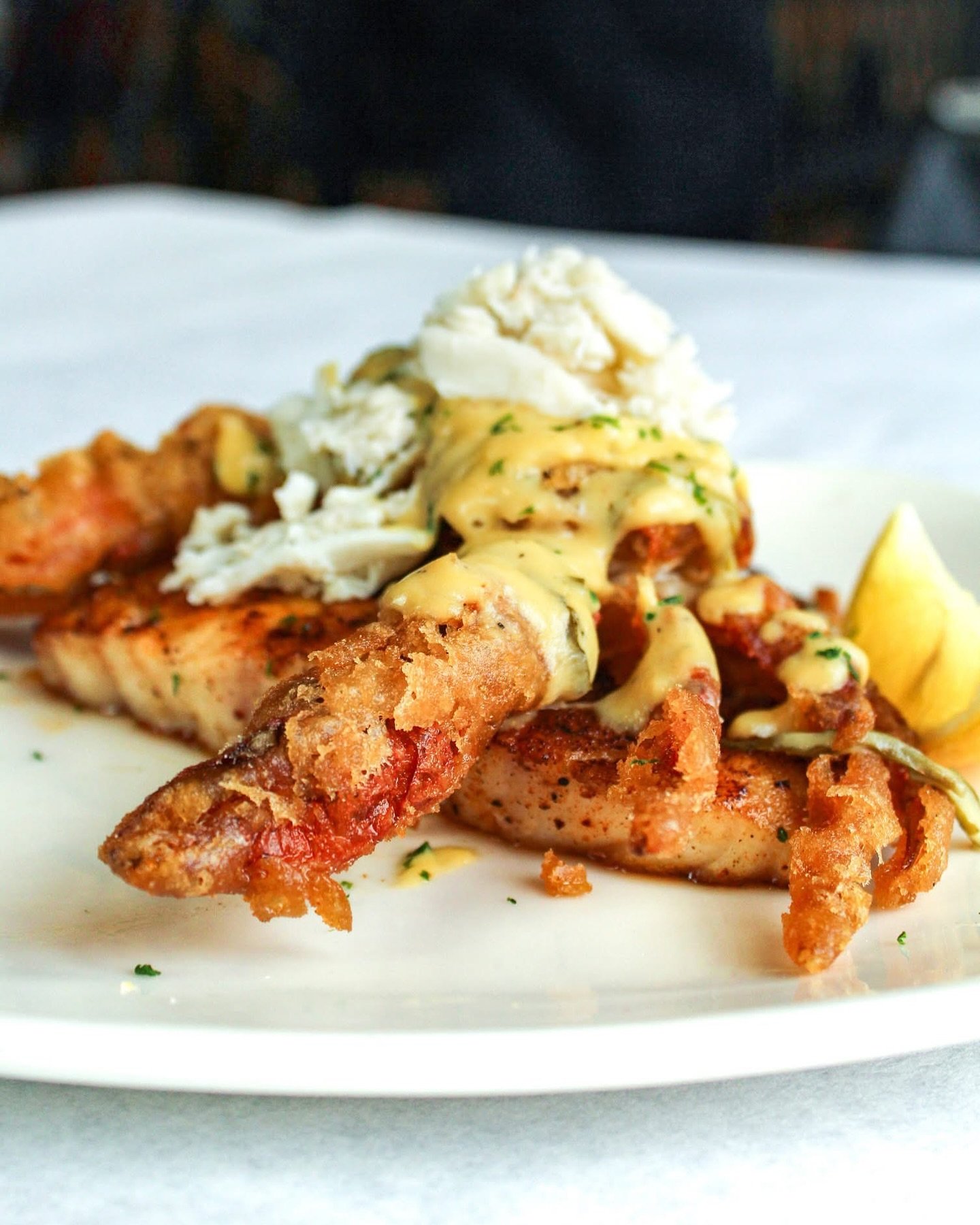 Our twist on a Louisiana classic! The Grouper Pontchartrain is only here for a limited time. 

Blackened grouper topped with a softshell crab, fried golden in a crispy creole seasoned tempura batter. Finished with our homemade Bearnaise sauce and lum