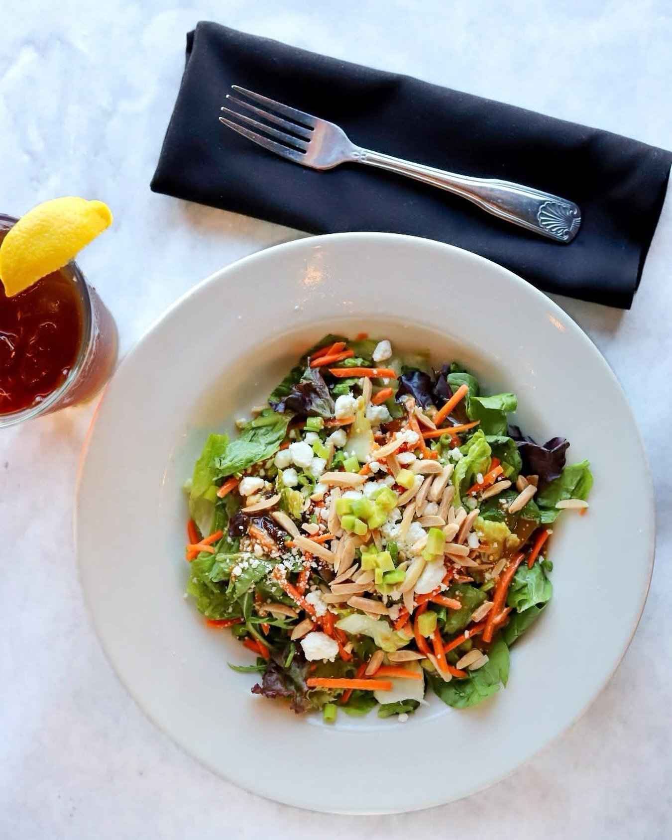 The weather&rsquo;s heating up and so are our cravings for something fresh, light, and SO good! Welcome summer with our Half Shell Salad&mdash;spring mix, goat cheese, toasted almonds, tomatoes, carrots, chives, and our house-made roasted garlic bals