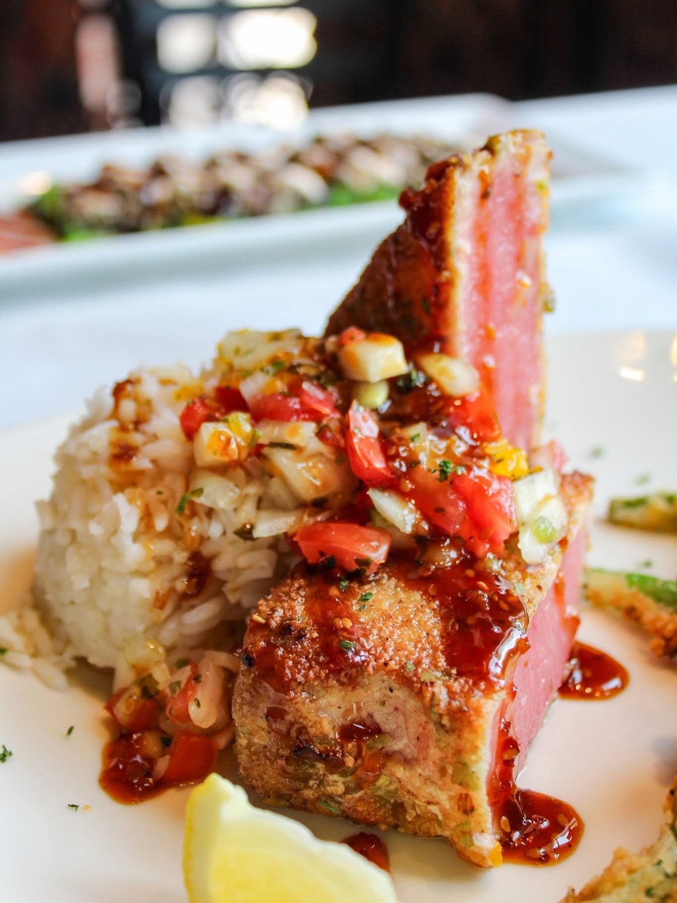 Light, fresh, vibrant, full of flavor... what else could you ask for in a summer meal?! ☀️🌊

Say hello to our NEW Wasabi Encrusted &mdash; Sashimi grade Yellowfin tuna, wasabi pea crust, white rice, Mandarin orange pico de gallo, teriyaki glaze, swe