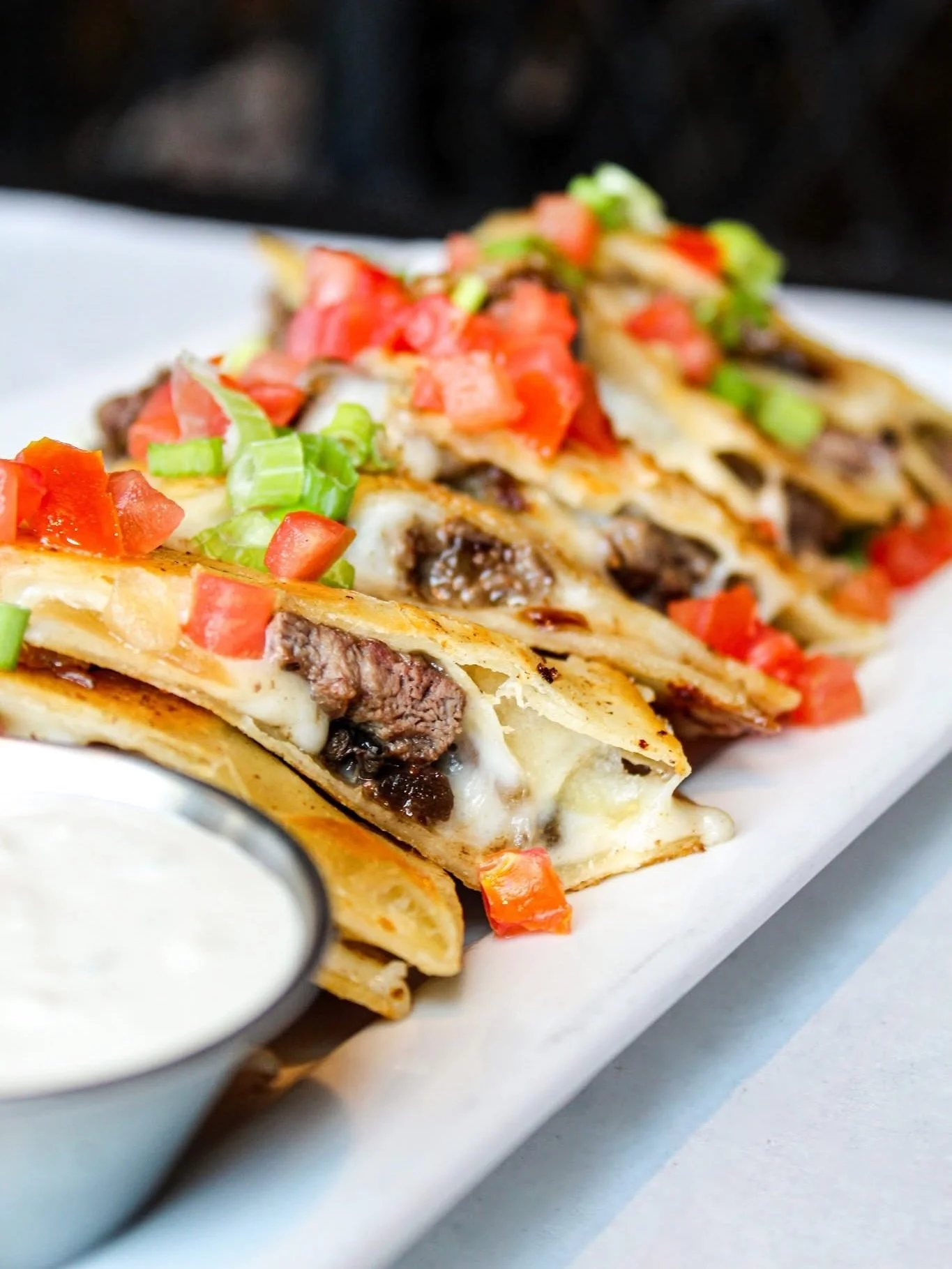 Naughty or nice, everyone deserves an Uptowner Quesadilla this time of year. 🎄🎁

Sliced filet and ribeye with saut&eacute;ed mushrooms, onions, green bell peppers, and a five cheese blend in a flour tortilla. Topped with chives and diced tomatoes. 