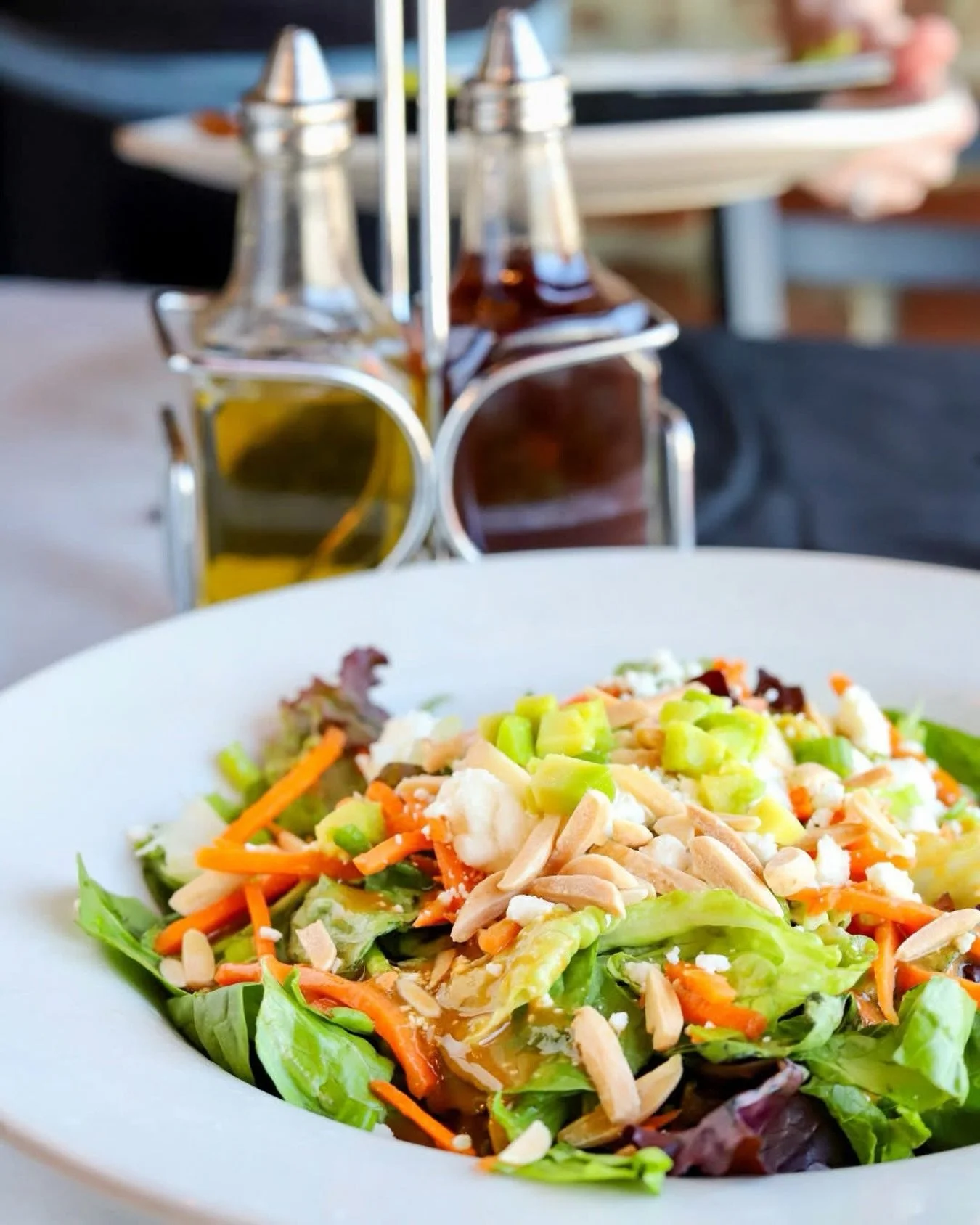 Looking for lighter options this summer? ☀️ Try our Half Shell Salad &mdash; Romaine and spring mix, goat cheese, toasted almond slices, chives, tomatoes, and shredded carrots. Served with our signature roasted garlic balsamic house vinaigrette! 

⭐️